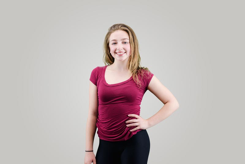 smiling girl with hand on hip