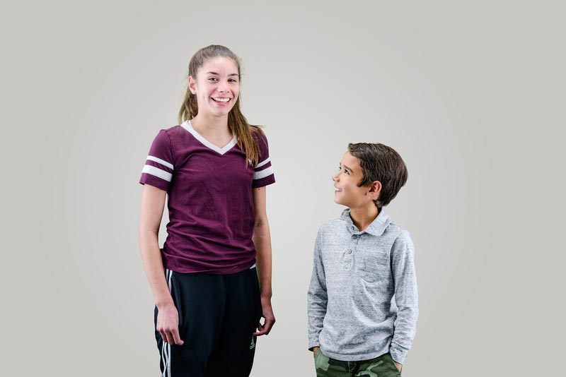 two siblings smiling
