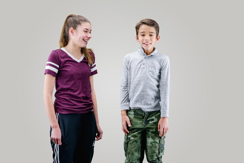 two siblings smiling